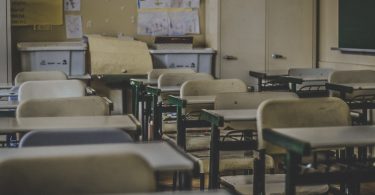 Photo of a classroom with yellow chairs and walls