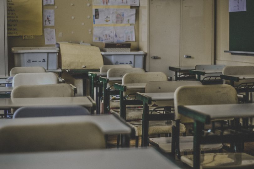 Photo of a classroom with yellow chairs and walls